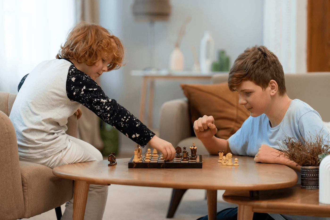 Two kids playing chess together