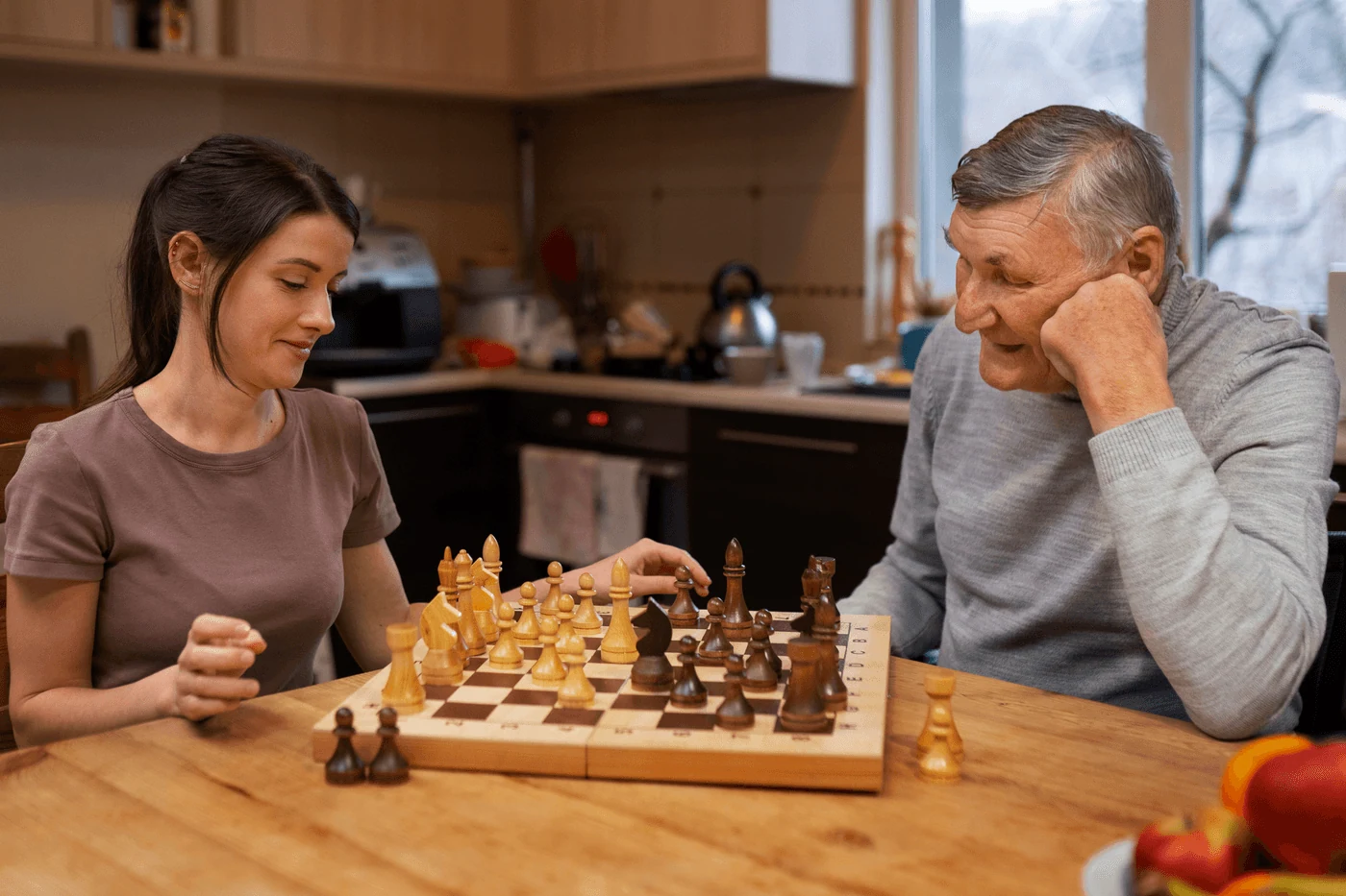 A parent and a young student playing chess